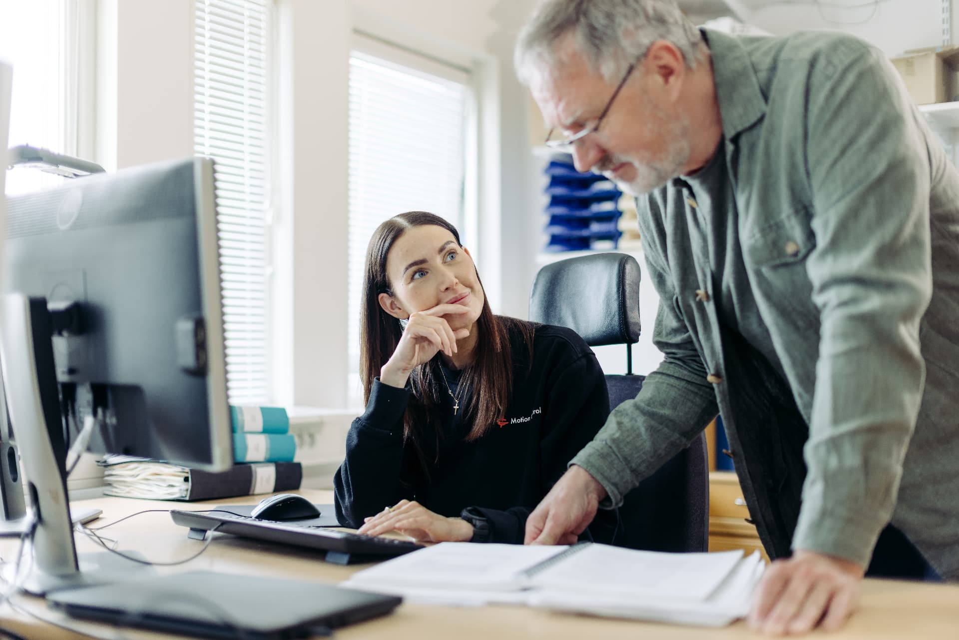 Colleagues reviewing documents at a desk